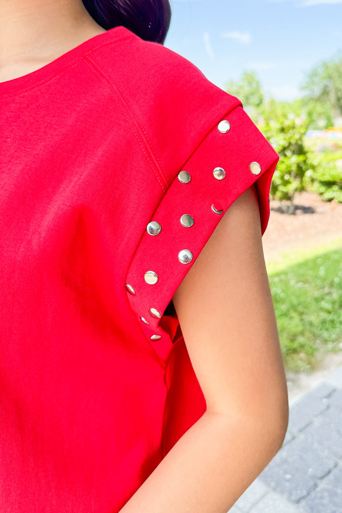 red tee with silver studded sleeves 