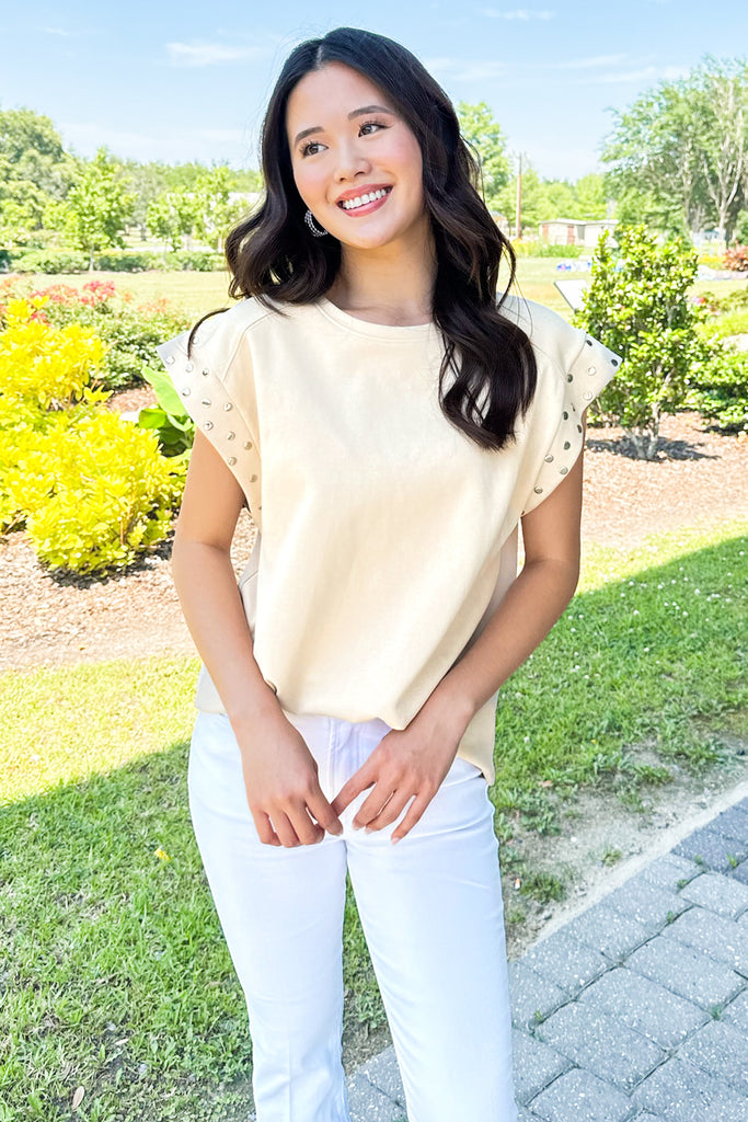 cream colored tee with silver studded sleeve