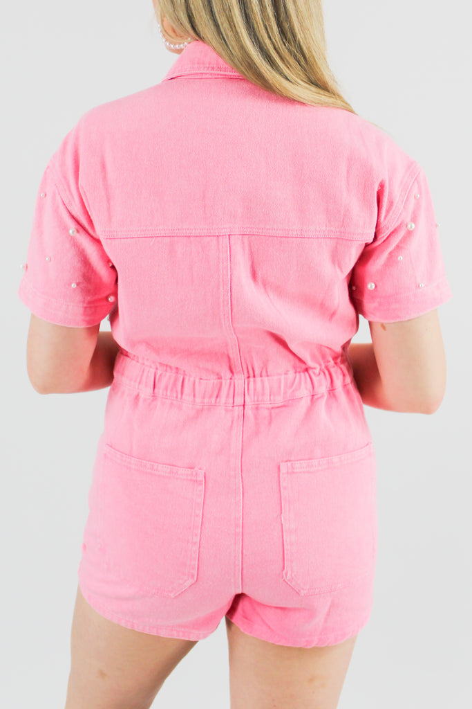 Bright pink, pearl embellished denim romper with a cinched waist and cargo pockets
