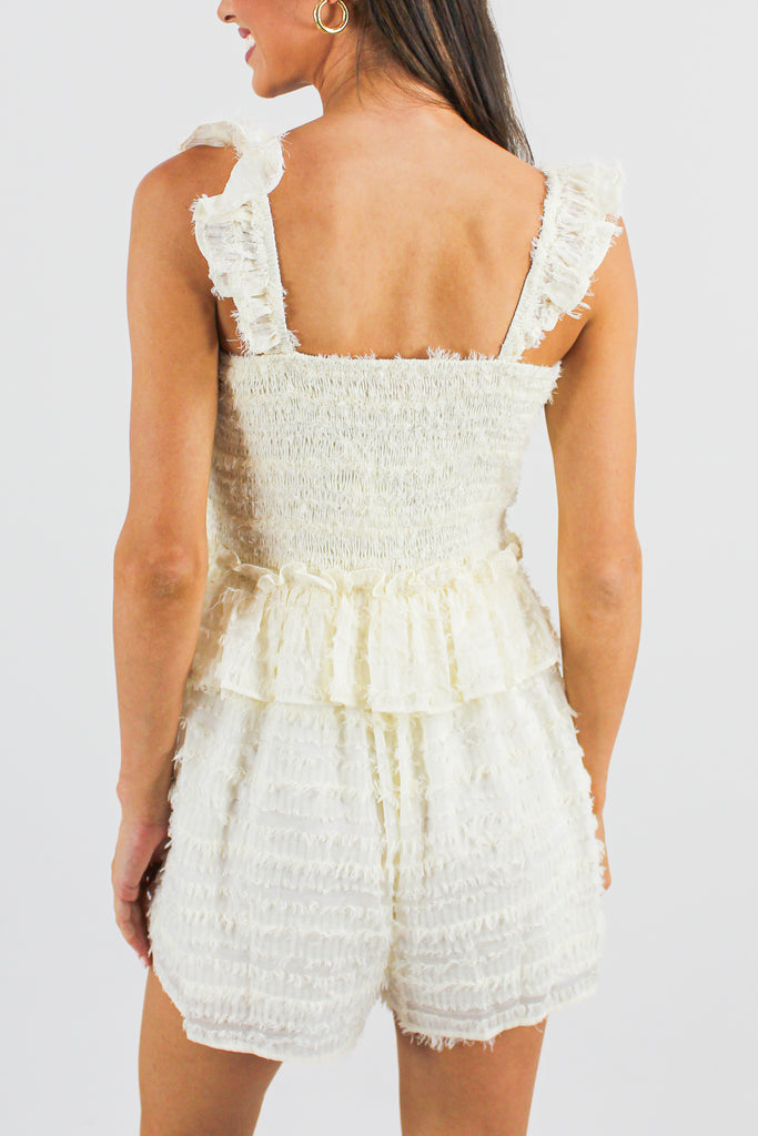cream frayed smocked tiered romper with flutter straps