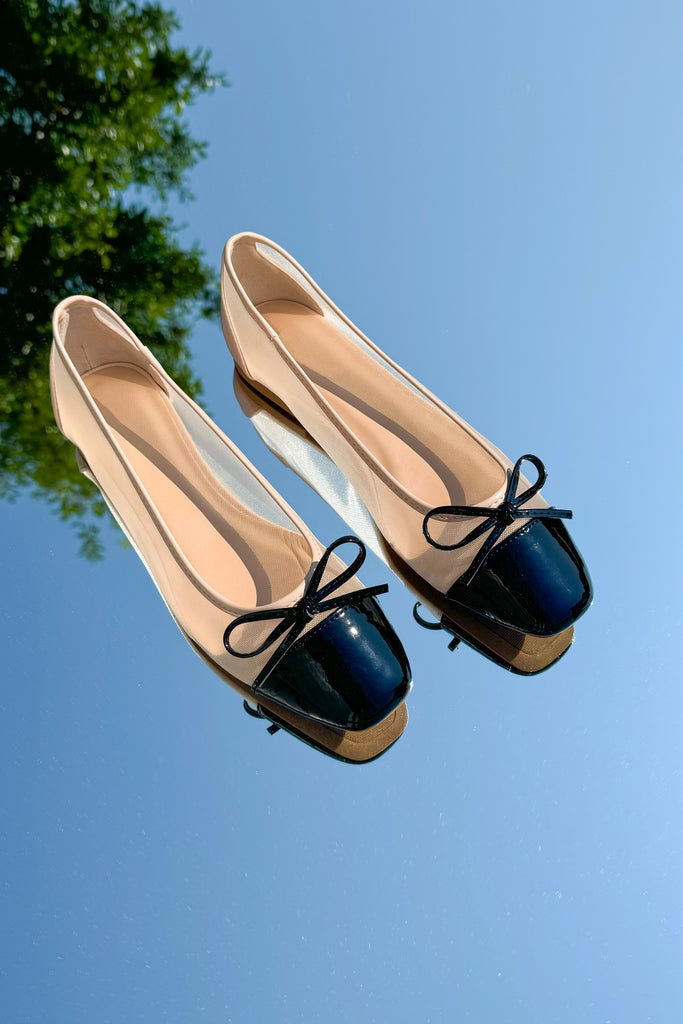 mesh ballet flats in nude with a black bow on the front with a patent black toe cap