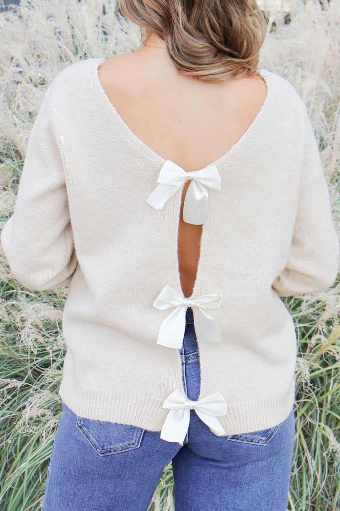 cream open back sweater with bows