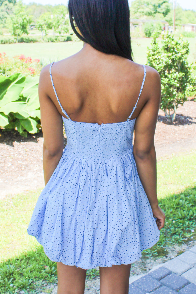 light blue pleated babydoll dress with navy polka dots and bow details