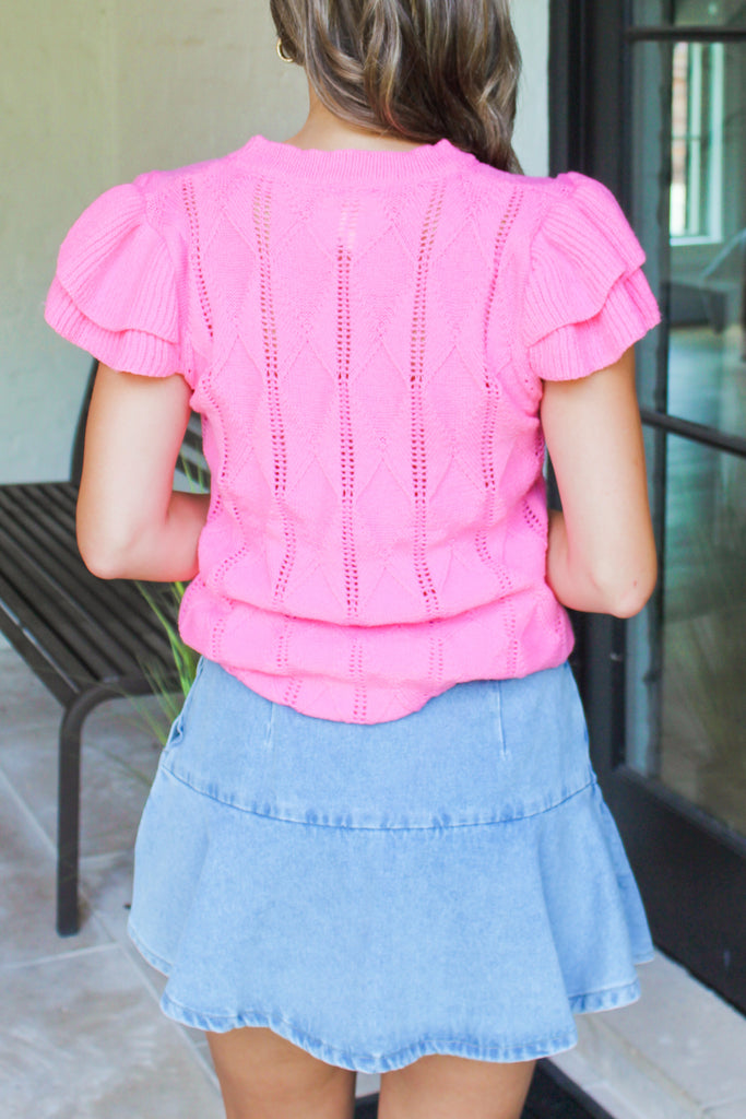 back of Neon pink cable knit top with flutter short sleeves